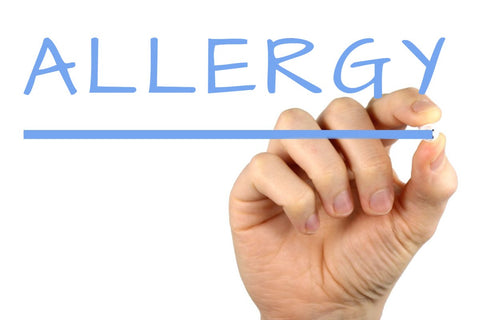 picture of a hand writing the word allergy img src wikipedia commons