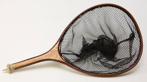 large fly fishing net with object inlayed into handle. These are