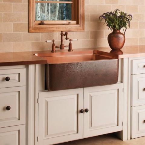 drop-in copper sink in a kitchen counter country style