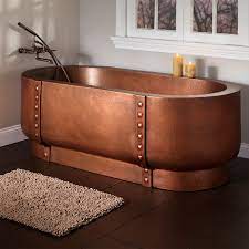 copper tub with rivets in a custom bathroom