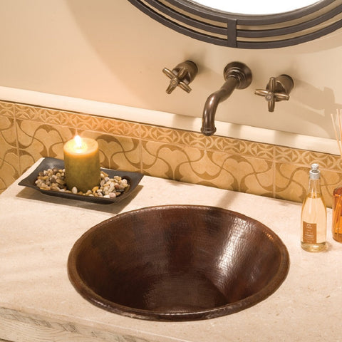 hammered decorative copper sink in a bathroom vanity