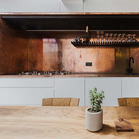 copper kitchen backsplash installed on the wall