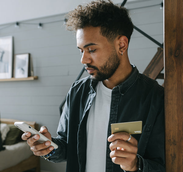 black man shopping via cellphone