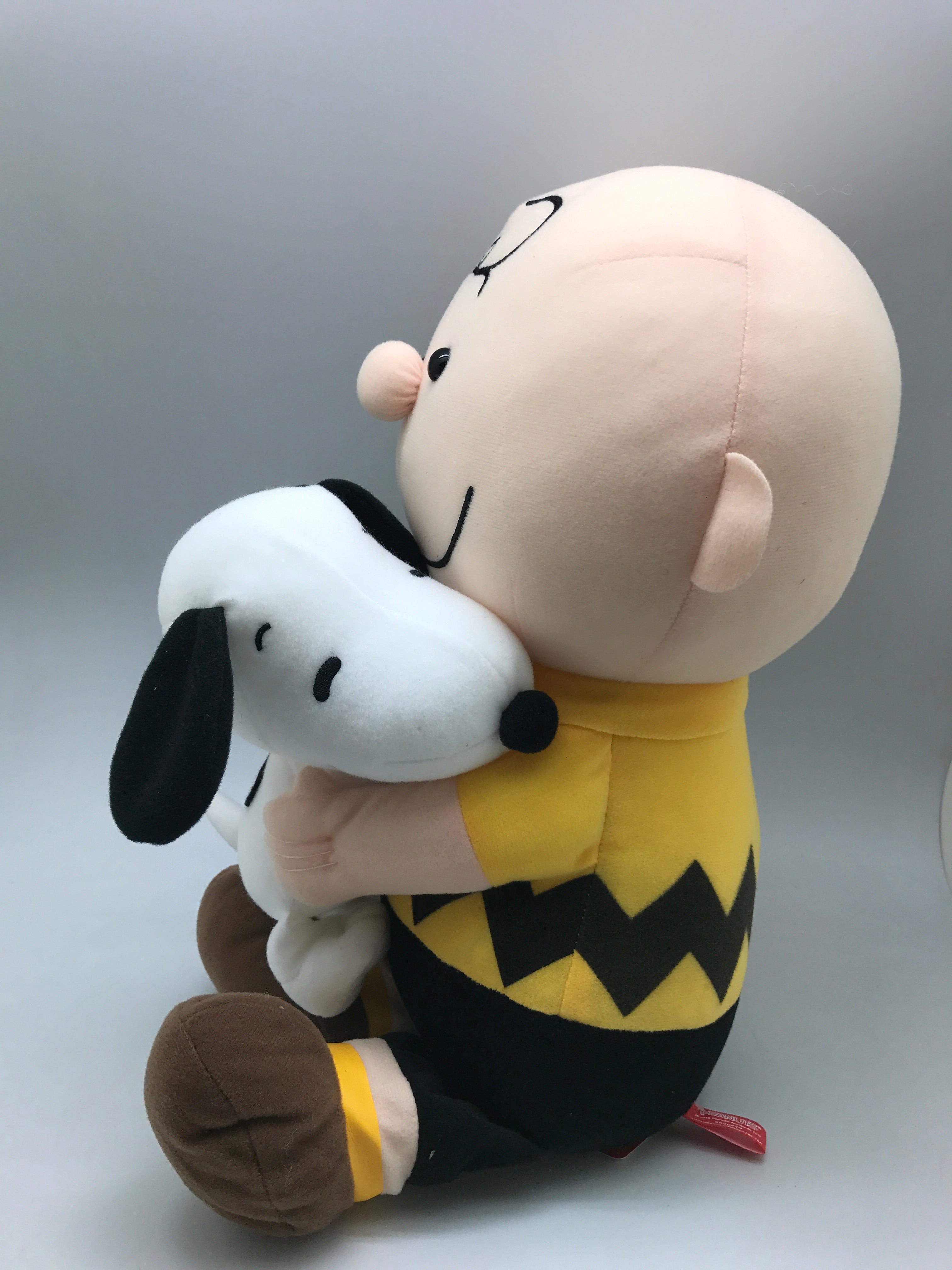 charlie brown hugging snoopy plush