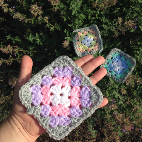 pastel granny squares on top of lavender flowers