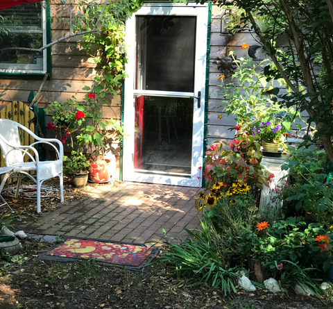 The front door of the pickle house, flanked by flowers everywhere