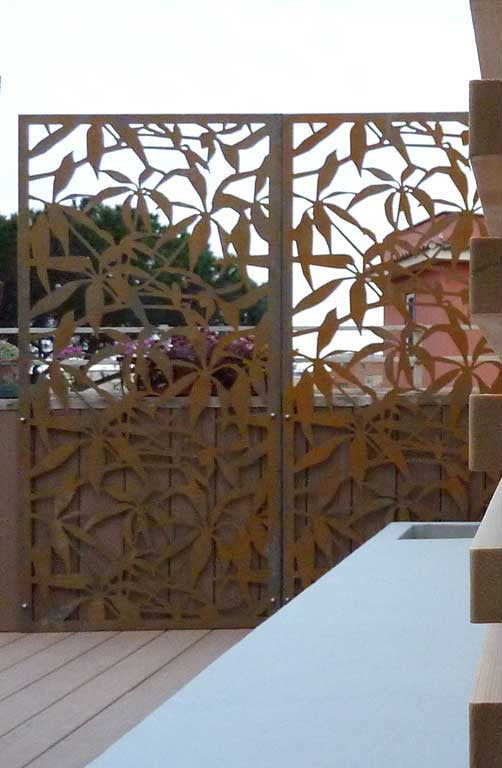 Raw CorTen steel screens with laser cut Schefflera design fixed to the parapet