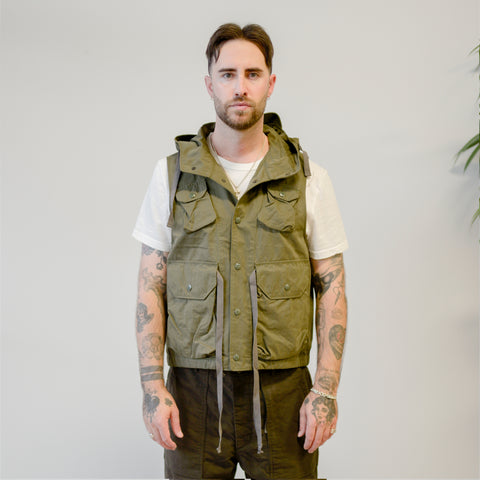 Model wearing Engineered Garments vest and fatigue pants