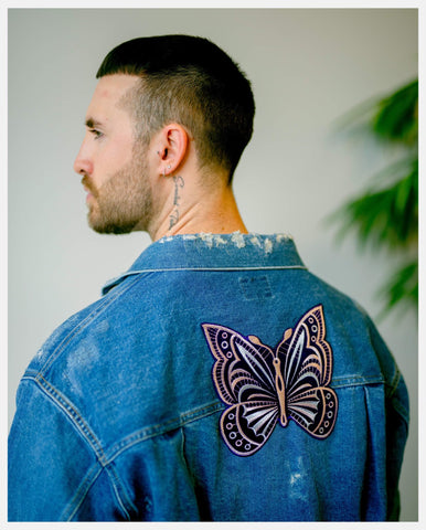 Model wearing Needles denim jacket Papillon patch