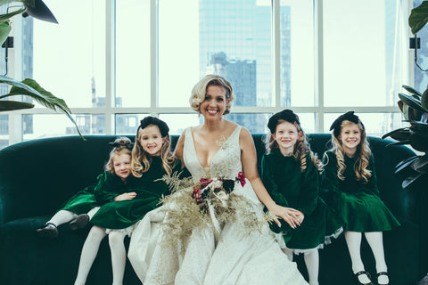 Bride and four flower girls pose in our green velvet dresses.