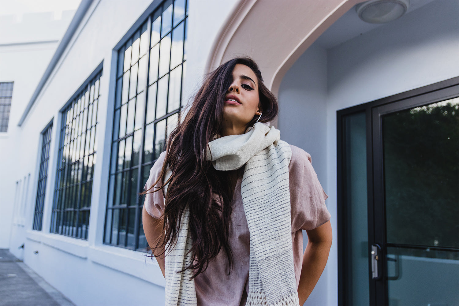 Model, Gia, wearing a natural color scarf with a pink shirt.