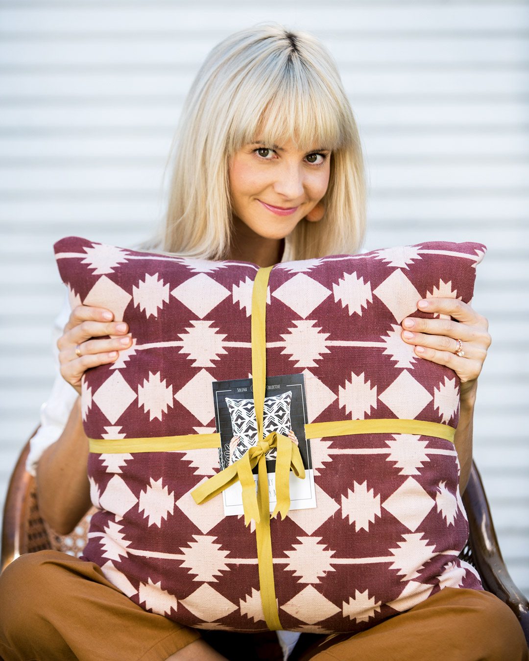 Photo of Kestrel on chair with our pillow and packaging