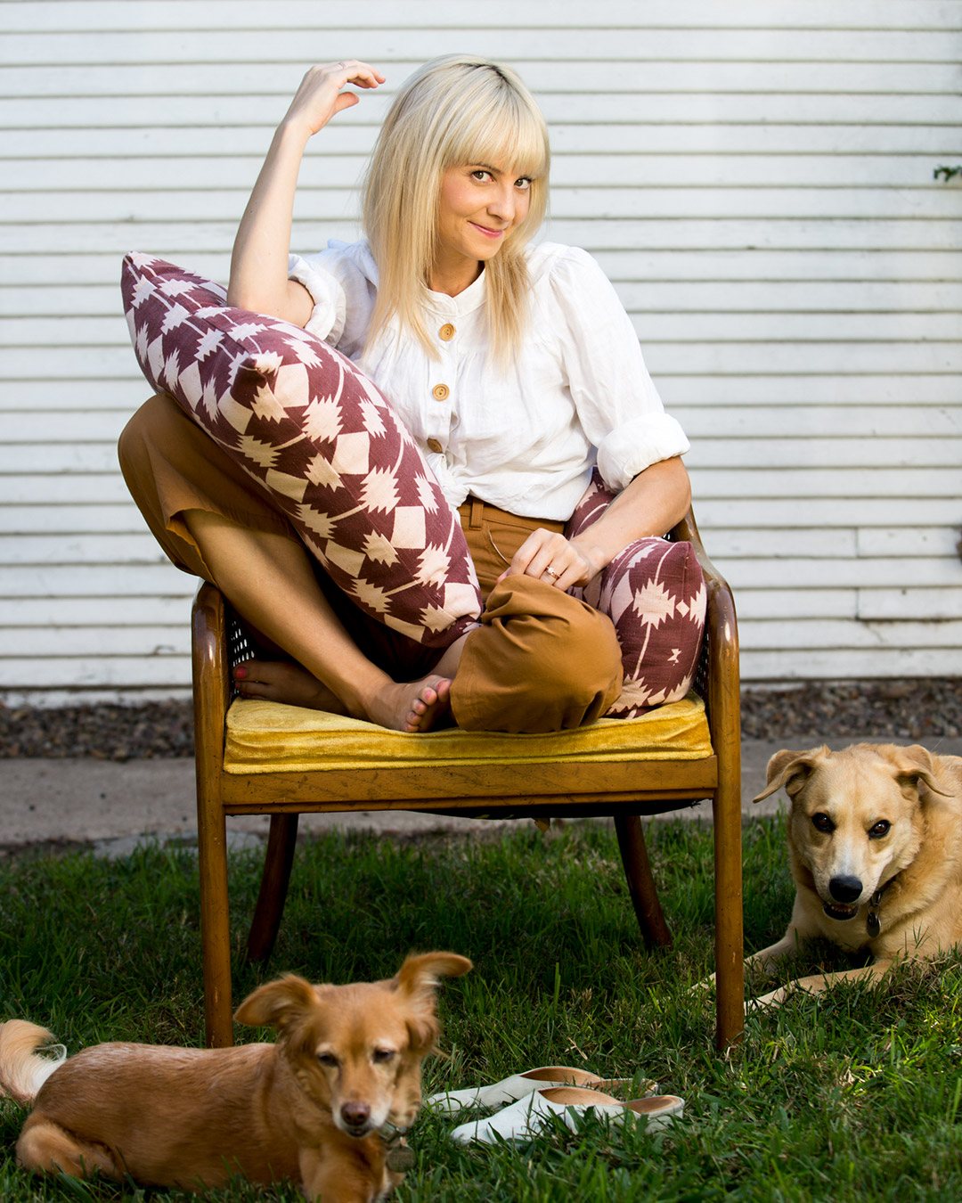 Photo of Kestrel on chair with our pillow with her dogs.