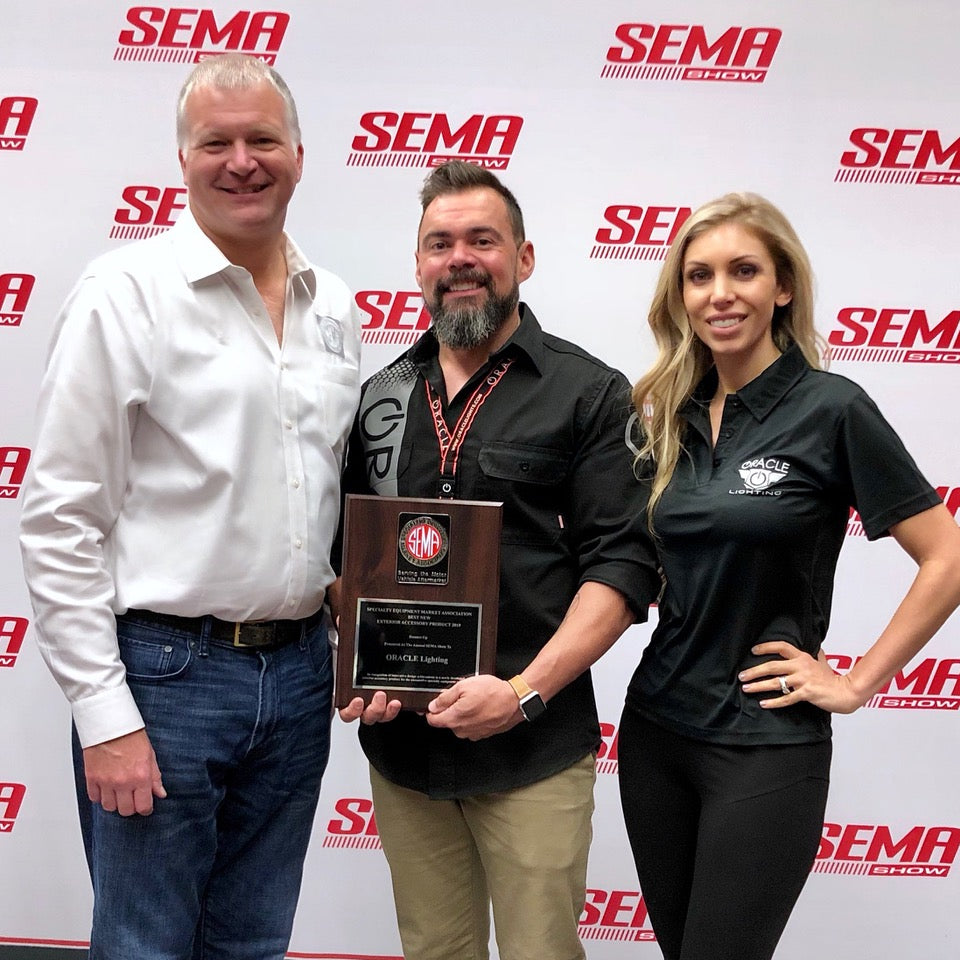 Justin and Tiffanie Hartenstein Stand with unnamed for their Global Media Award at SEMA SHOW 2018