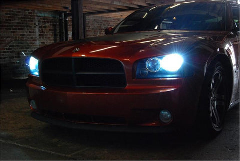 Dodge vehicle parked in the dark with the lights on