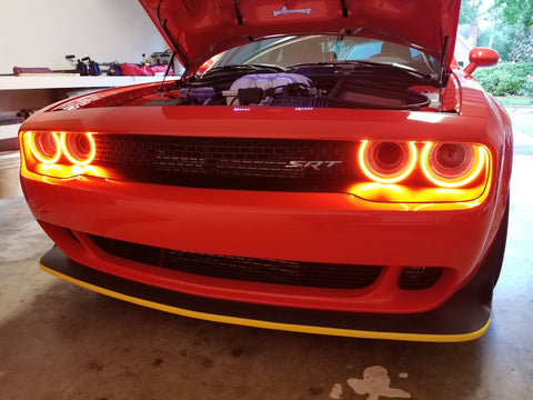 Red vehicle with yellow halo headlights