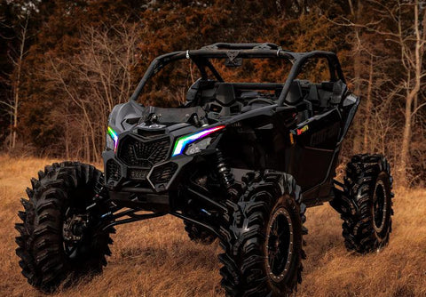 atv with multicolored headlights in a forest