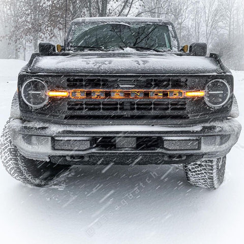 Front view of ford bronco with glowing orange LED letter badges