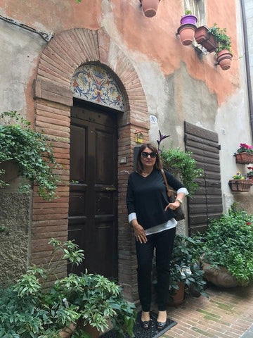 Alice Margaritelli striking a pose in front of an Italian door with hand painted motif in Deruta Italy