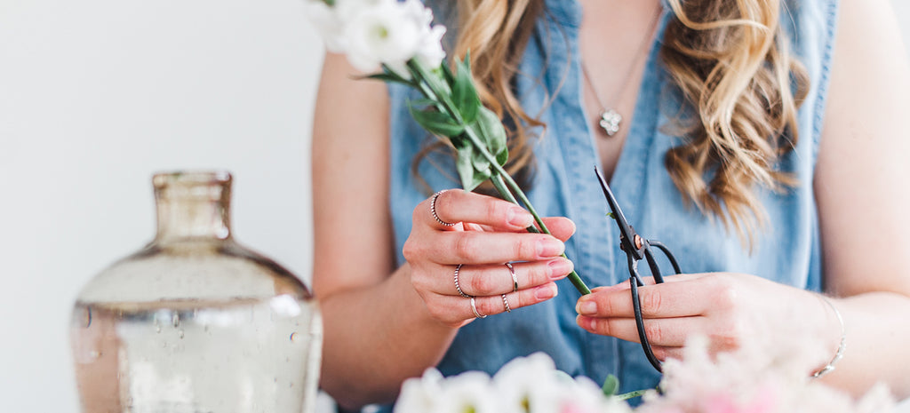 woman cutting flowers for vase