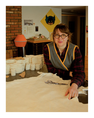 Haviland Justice at her sewing table making toy bunnies