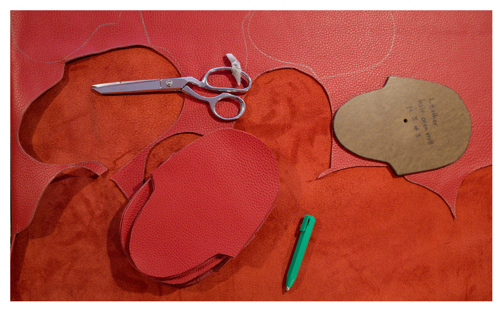 oven mitts being cut out red leather