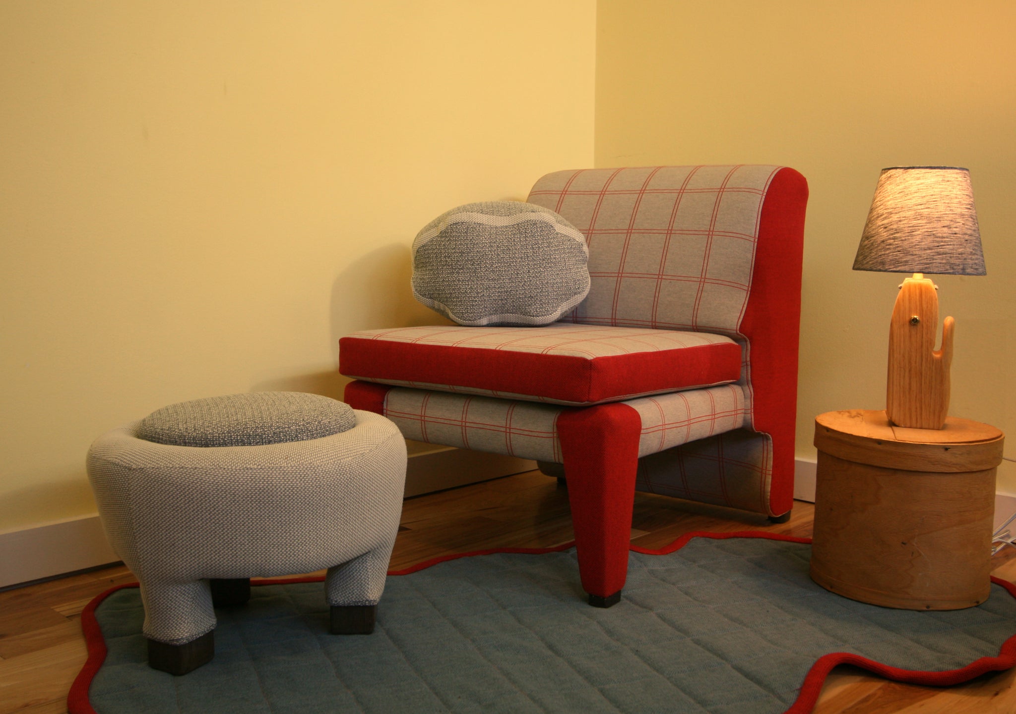 sheep ottoman, pelted grid rug, lineament chair, sheep pillow, log lamp.
