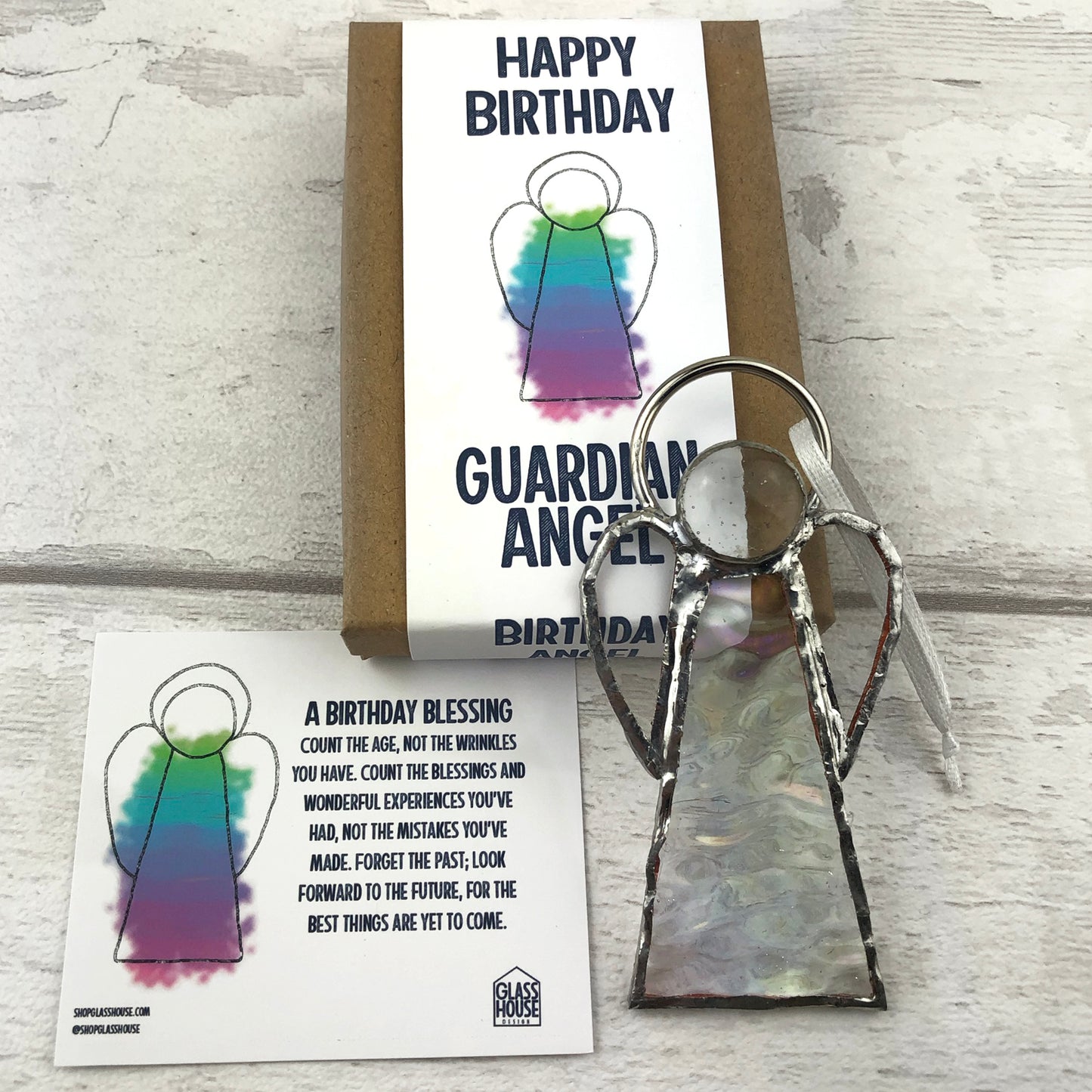 Flatlay showing clear birthday angel, birthday information card and the packaging box