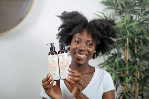 Afrocenchix How to do the PERFECT Twist out on Natural Hair: Beautiful black woman with afro hair holding Afrocenchix shampoo and conditioner