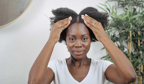 Afrocenchix How to do the PERFECT Twist out on Natural Hair: Beautiful black woman with afro hair parting her hair