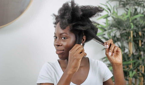 Afrocenchix How to do the PERFECT Twist out on Natural Hair: Beautiful black woman with afro hair styling it into twists