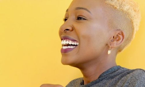 smiling black woman with short blonde hair