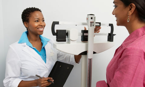  Afro hair care for essential workers: black female doctor with short afro hair and patient