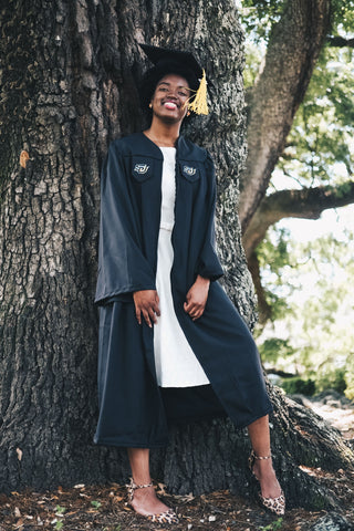 Afrocenchix graduation Hairstyles for natural hair: black woman wearing a graduation cap standing under a tree