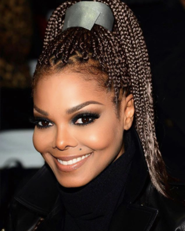 Janet Jackson with single box braids in a high ponytail