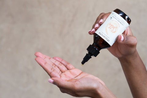 Image of hand model displaying, Soothe, a lightweight scalp oil, 