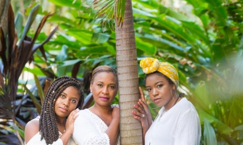 Three black women in the tropics with natural hair