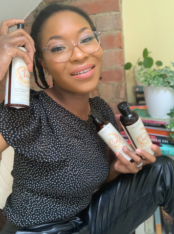 Rachael Corson holding Afrocenchix products for Rosa Parks Black HairStory