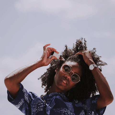 itchy scalp treatment product: black woman applying Afrocenchix oil to scalp