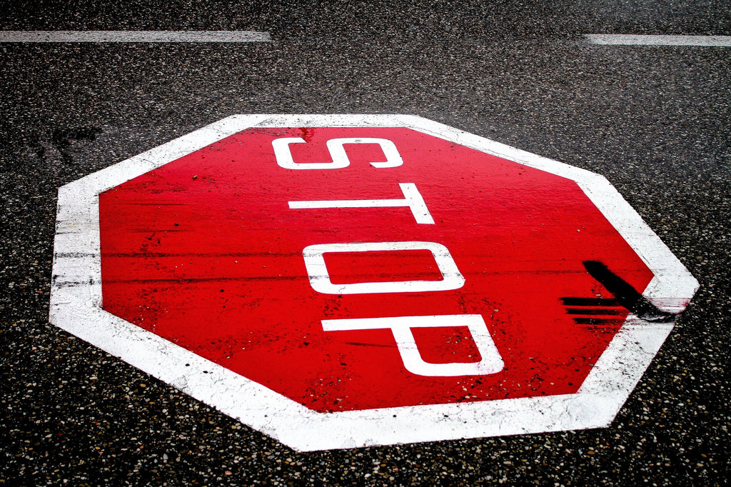 Stop Sign Painted on Asphalt