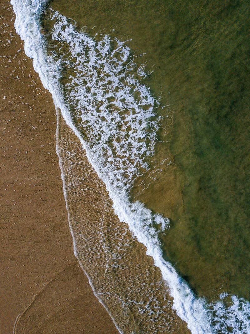 Aerial photograph of turquoise wave breaking in Costa Rica. Fine art aerial photography print Photographed by Kristen M. Brown, Samba to the Sea for The Sunset Shop.