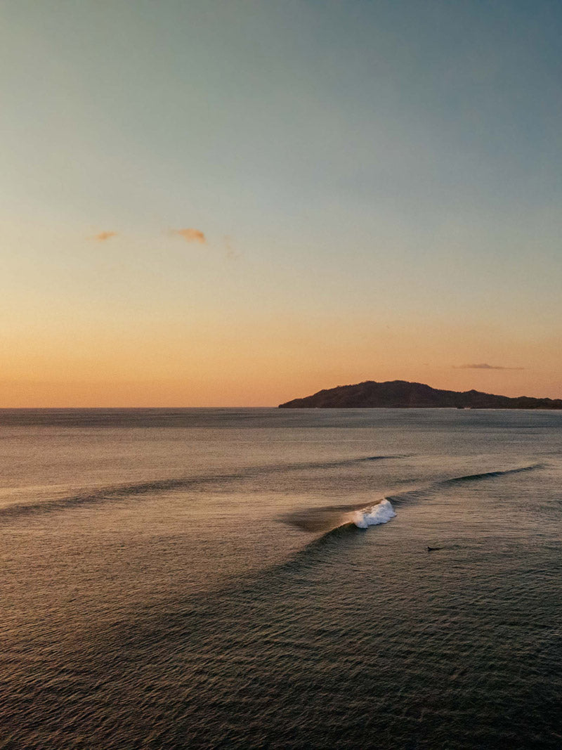 Aerial photo of waves breaking in Tamarindo Costa Rica. Photographed by Kristen M. Brown, Samba to the Sea for The Sunset Shop.