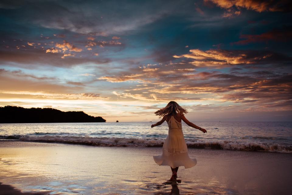Girl dancing on the beach during a gorgeous sunset in Playa Conchal Costa Rica. Photographed by Kristen M. Brown, Samba to the Sea for The Sunset Shop.
