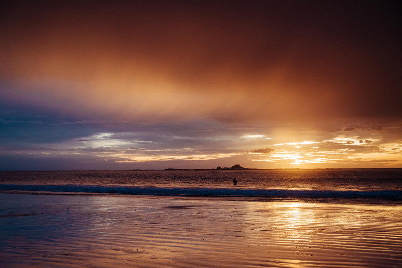 Bather taking in sunset in Tamarindo Costa Rica. Photographed by Kristen M. Brown, Samba to the Sea for The Sunset Shop.