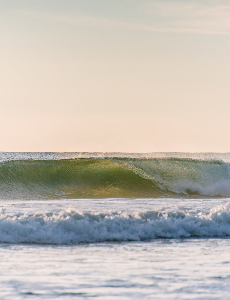 Backlit turquoise wave breaking in Tamarindo Costa Rica. Photographed by Kristen M. Brown, Samba to the Sea for The Sunset Shop.