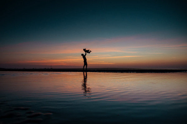 Family sunset in Tamarindo, Costa Rica. Photographed by Kristen M. Brown, Samba to the Sea. Sunset print at The Sunset Shop.