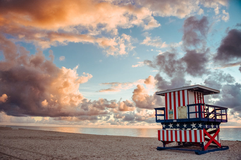 Sunrise over American flag lifeguard tower Miami Beach Florida. Photographed by Kristen M. Brown, Samba to the Sea.
