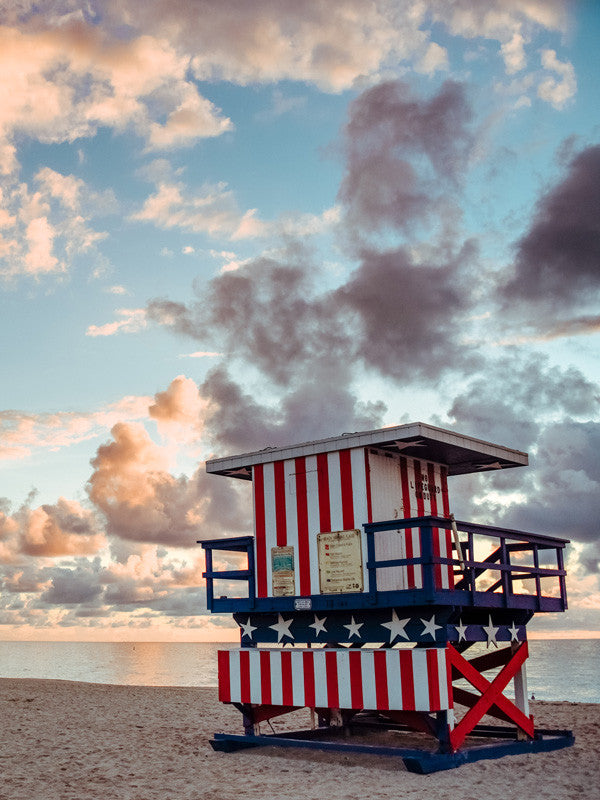 Sunrise over American flag lifeguard tower Miami Beach Florida. Photographed by Kristen M. Brown, Samba to the Sea.