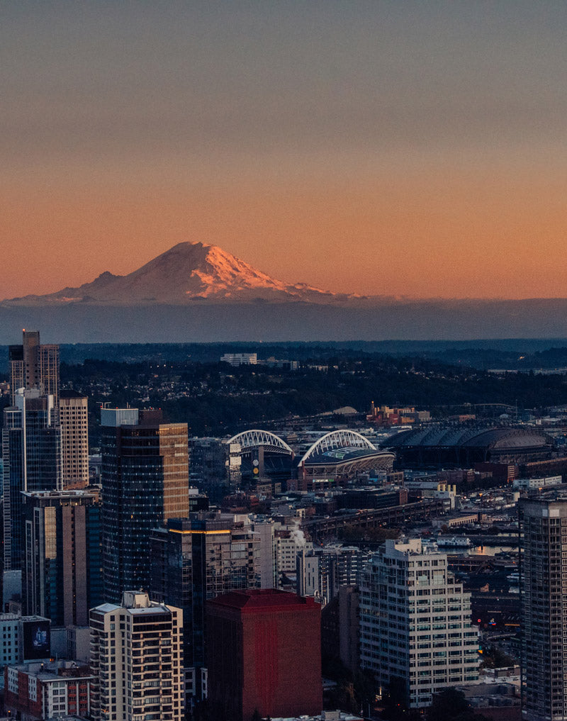Sunset sky in Seattle Washington. View of Mount Rainier from the Space Needle at sunset. Photographed by Kristen M. Brown, Samba to the Sea for The Sunset Shop.