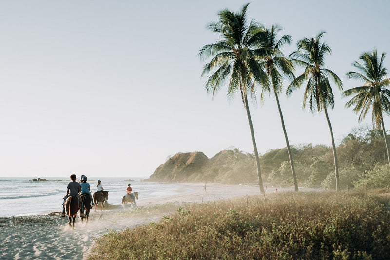 Horseback riding on the beach in Nosara Costa Rica. Beach fine art photography by Kristen M. Brown, Samba to the Sea for The Sunset Shop.